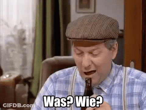 A Man In A Plaid Shirt And Hat Is Holding A Bottle Of Beer And Asking Was ? Wie ? GIF
