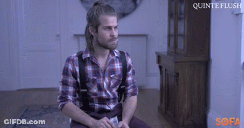 A Man In A Plaid Shirt And Suspenders Sits On A Couch With The Words Quinte Flush On The Bottom GIF