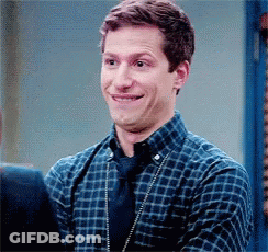 Man In Plaid Shirt And Tie Smiling Next To Another Man GIF