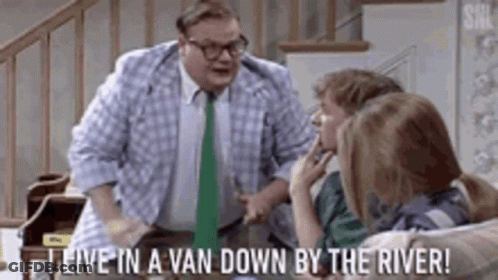 A Man In A Plaid Shirt And Tie Is Standing In Front Of A Group Of Children . GIF