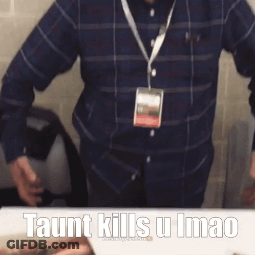A Man In A Plaid Shirt Has A Lanyard Around His Neck With The Words Taunt Kills U Imao On It GIF