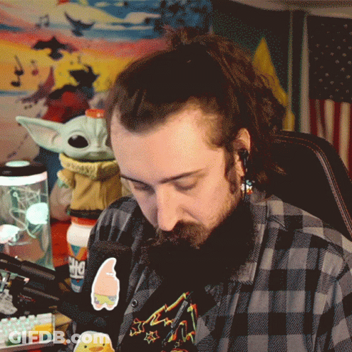 A Man In A Plaid Shirt Has A Sticker On His Shirt That Says Spongebob On It GIF
