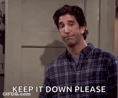 A Man In A Plaid Shirt Is Asking To Keep It Down Please GIF