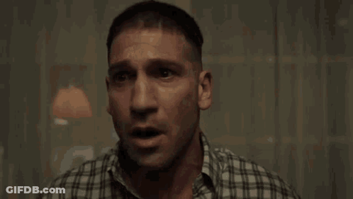 A Man In A Plaid Shirt Is Crying While Holding A Box In His Hand . GIF