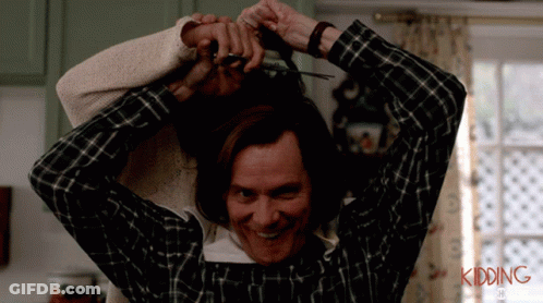 A Man In A Plaid Shirt Is Cutting A Woman 'S Hair With The Words Kidding Written On The Bottom GIF
