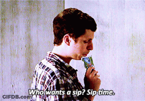 A Man In A Plaid Shirt Is Eating An Ice Cream Cone And Says Who Wants A Sip GIF