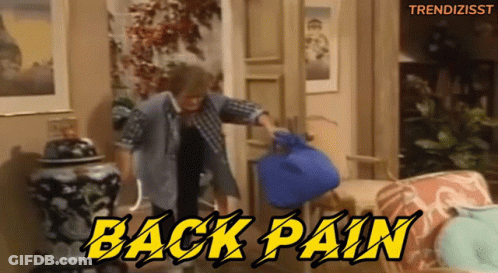 A Man In A Plaid Shirt Is Holding A Blue Bag With The Words Back Pain Written Above Him GIF