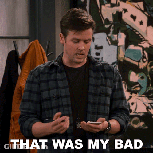 A Man In A Plaid Shirt Is Holding A Cell Phone And The Words That Was My Bad Are Behind Him GIF