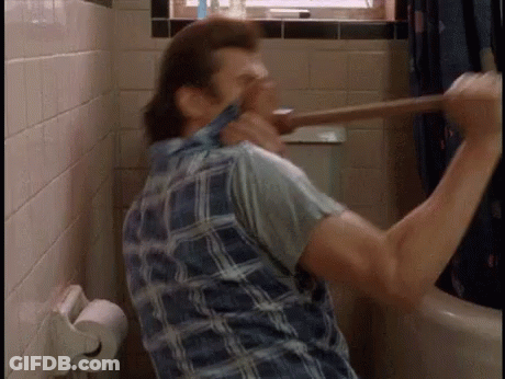 A Man In A Plaid Shirt Is Holding A Plunger In His Hand GIF