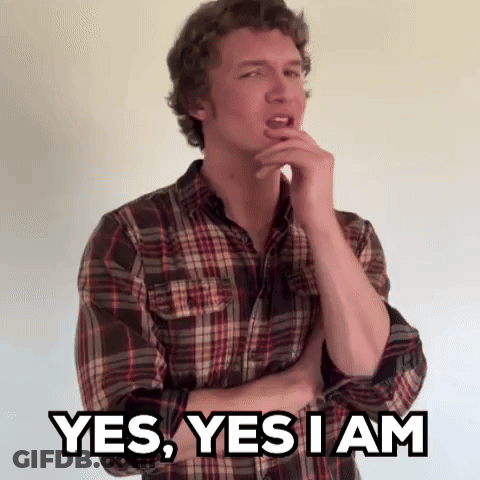 A Man In A Plaid Shirt Is Holding His Hand To His Chin And Says Yes , Yes I Am . GIF