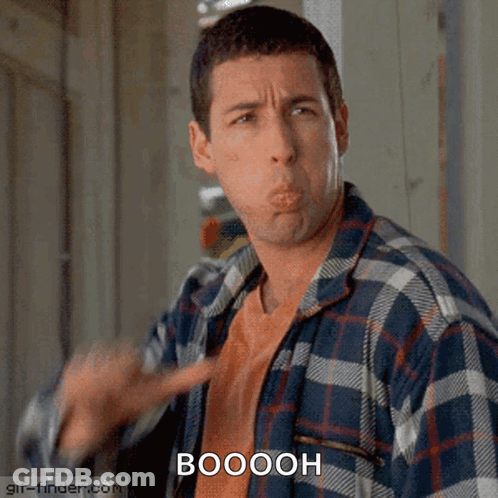 A Man In A Plaid Shirt Is Making A Funny Face And The Word Booooh Is Above Him GIF