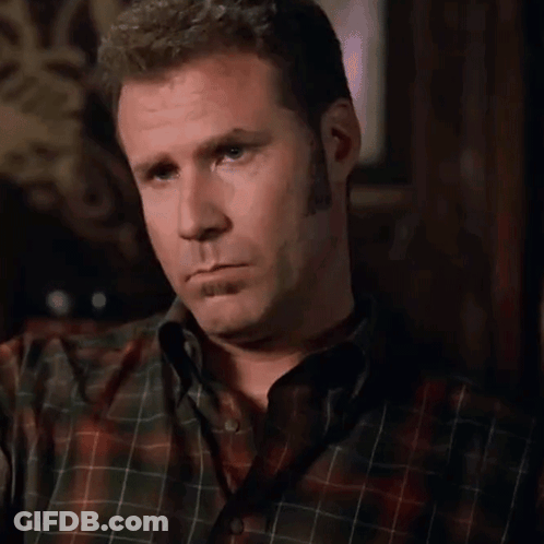 A Man In A Plaid Shirt Is Making A Silly Face GIF