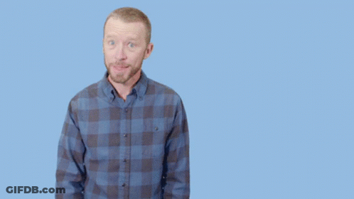 A Man In A Plaid Shirt Is Pointing Up And The Words Brilliant Are Behind Him GIF