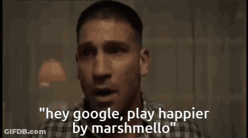A Man In A Plaid Shirt Is Saying " Hey Google Play Happier By Marshmellow " GIF