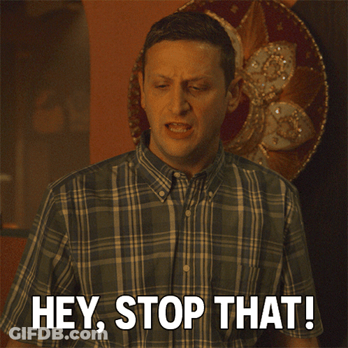 A Man In A Plaid Shirt Is Saying " Hey Stop That " GIF