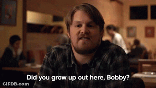 Man In Plaid Shirt Talking At Restaurant GIF