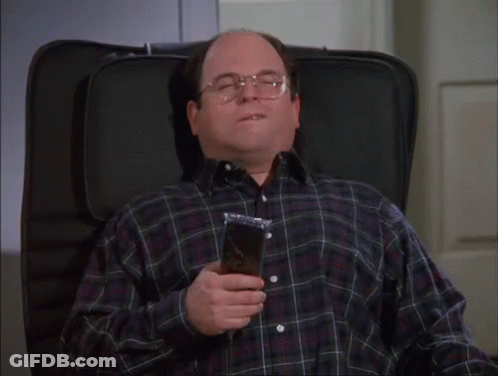 A Man In A Plaid Shirt Is Sitting In A Chair With His Eyes Closed And Holding A Bag Of Food GIF