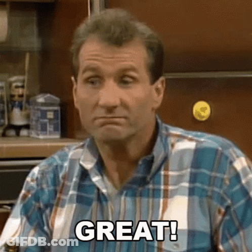 Man In Plaid Shirt Sitting In Kitchen GIF