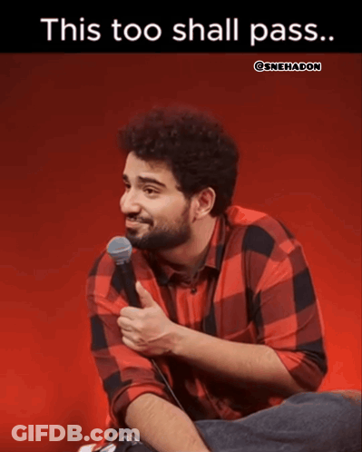 A Man In A Plaid Shirt Is Sitting In Front Of A Microphone With The Caption " This Too Shall Pass " GIF