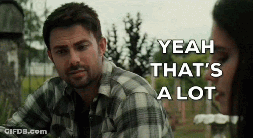 A Man In A Plaid Shirt Is Sitting Next To A Woman In A Cemetery . GIF