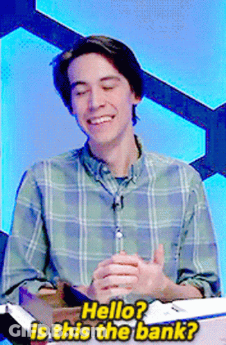 A Man In A Plaid Shirt Is Smiling And Asking " Hello " GIF