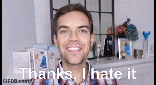 A Man In A Plaid Shirt Is Smiling And Saying Thanks , I Hate It GIF
