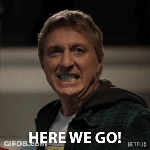 A Man In A Plaid Shirt Is Smiling And Says Here We Go Netflix GIF