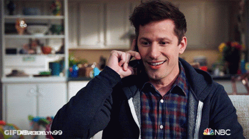 Man In Plaid Shirt Smiling On Phone NBC GIF