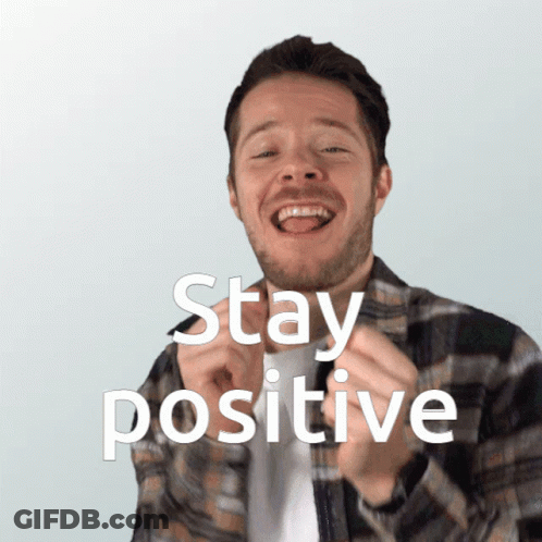 A Man In A Plaid Shirt Is Smiling With The Words Stay Positive Above Him GIF