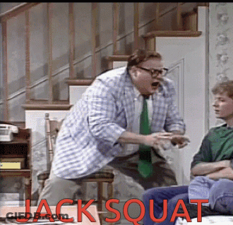 A Man In A Plaid Shirt Is Squatting In Front Of A Boy In A Green Shirt Who Is Sitting On A Couch GIF