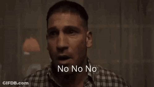 A Man In A Plaid Shirt Is Standing In A Dark Room With The Words Wait Wait Wait Wait Written Below Him . GIF