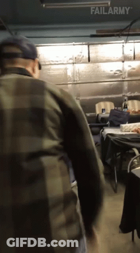 A Man In A Plaid Shirt Is Standing In A Garage With Failarmy Written On The Bottom Of The Screen GIF