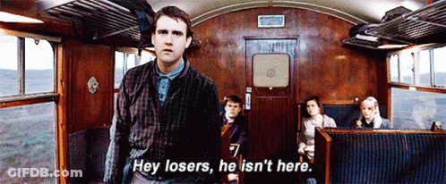 A Man In A Plaid Shirt Is Standing In A Train Car And Says Hey Losers He Is N't Here GIF