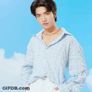 A Man In A Plaid Shirt Is Standing In Front Of A Coffee Maker GIF