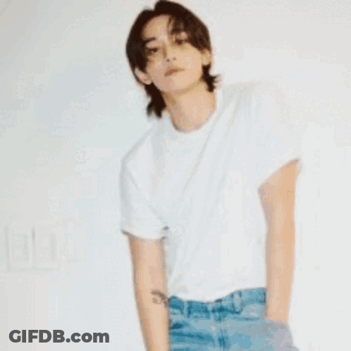 A Man In A Plaid Shirt Is Standing In Front Of A Coffee Maker GIF