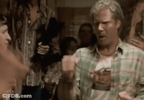 A Man In A Plaid Shirt Is Standing In Front Of A Group Of People . GIF
