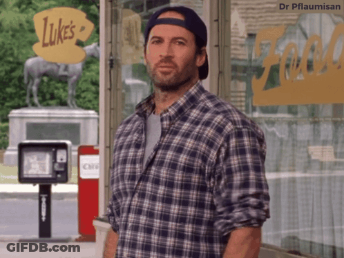 A Man In A Plaid Shirt Is Standing In Front Of Luke 'S GIF