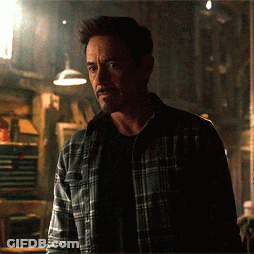 Man In Plaid Shirt Standing In Darkness GIF