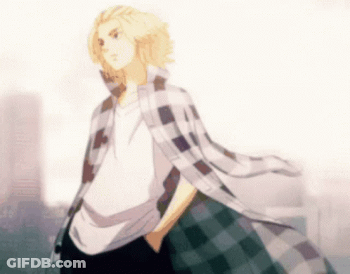 A Man In A Plaid Shirt Is Standing With His Hands In His Pockets In Front Of A City . GIF