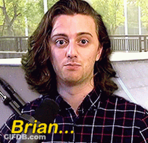 A Man In A Plaid Shirt Is Talking Into A Microphone And The Name Brian Is On The Bottom Right GIF