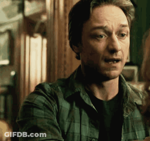 A Man In A Plaid Shirt Is Talking To A Woman In A Dark Room . GIF