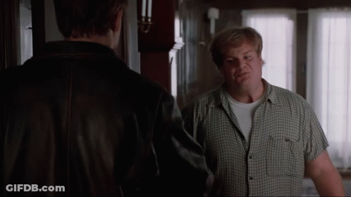 A Man In A Plaid Shirt Is Talking To Another Man In A Brown Jacket GIF