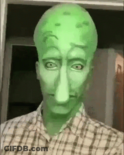 A Man In A Plaid Shirt Is Wearing A Squidward Mask . GIF