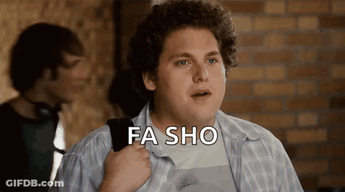 A Man In A Plaid Shirt Says Fa Sho In Front Of A Brick Wall GIF