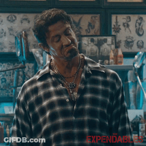 A Man In A Plaid Shirt Says " I 'M Good " In A Tattoo Shop GIF