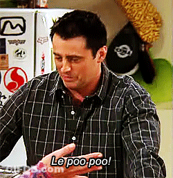 A Man In A Plaid Shirt Says Le Poo Poo In Front Of A Refrigerator GIF
