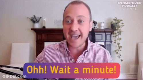 A Man In A Plaid Shirt Says " Ohh Wait A Minute " In Front Of A Fireplace GIF