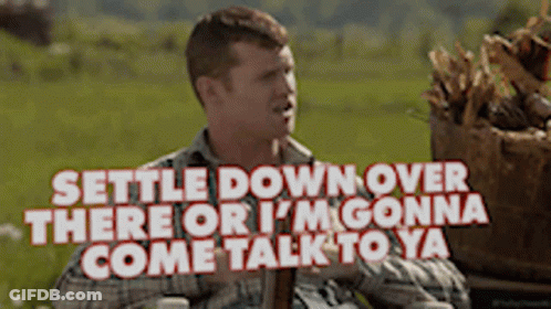 A Man In A Plaid Shirt Says Settle Down Over There Or I 'M Gonna Come Talk To Ya .. GIF
