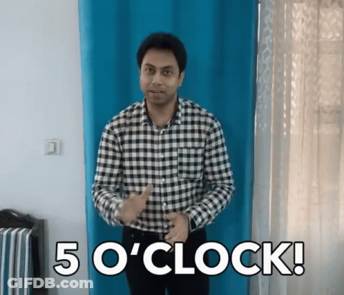 A Man In A Plaid Shirt Stands In Front Of A Blue Curtain And Says " 5 O ' Clock " GIF