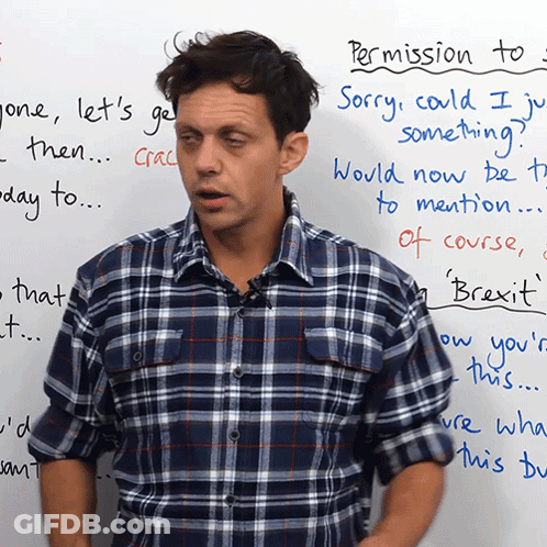 A Man In A Plaid Shirt Stands In Front Of A White Board That Says " Permission To " On It GIF